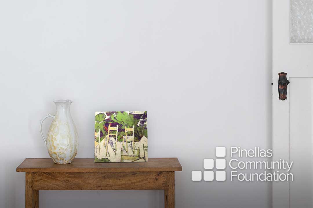 Abstract artwork of chairs on entryway table.