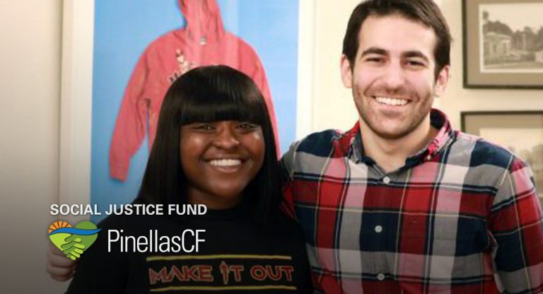 DaJuh Sawyer of the Make It Out Foundation accepts a grant from PCF Grant Manager David Bender.