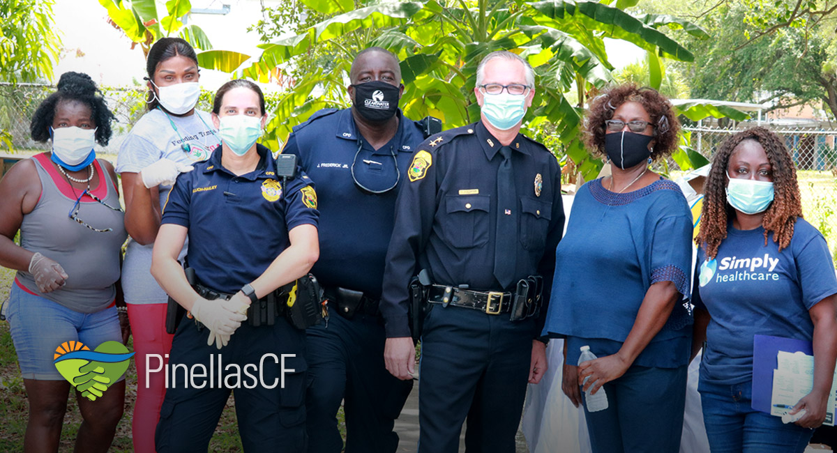 Clearwater MLK Community Center members gather with police officers for an event.
