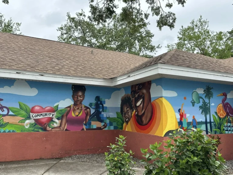 The Willa Carson Health and Wellness Center building, painted with a colorful community mural.